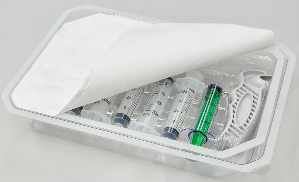 Plastic tray filled with syringes and needle holder with a Tyvek lid.