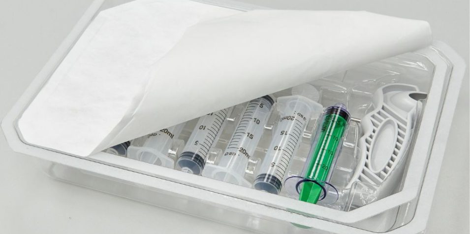 Plastic tray filled with syringes and needle holder with a Tyvek lid.