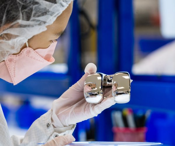 Sterile Medical Device Packaging Gloved hands holding a sterile medical device in clear packaging.
