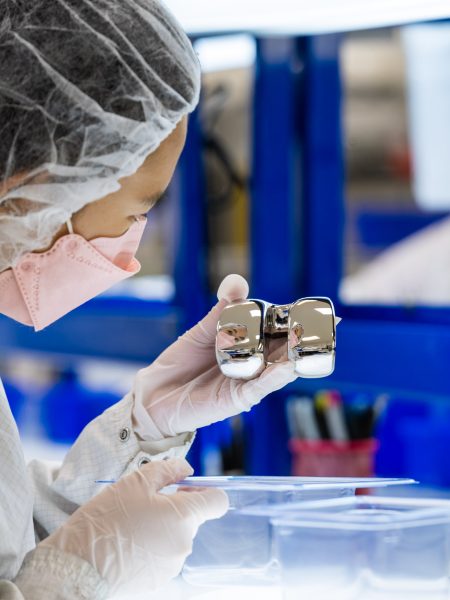 Sterile Medical Device Packaging Gloved hands holding a sterile medical device in clear packaging.