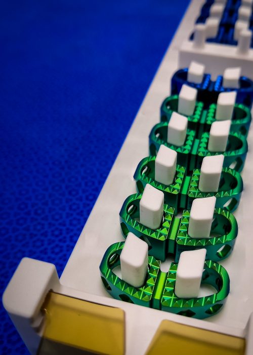 Close-up of anodized spinal implants organized in clean packaging for sterile assembly