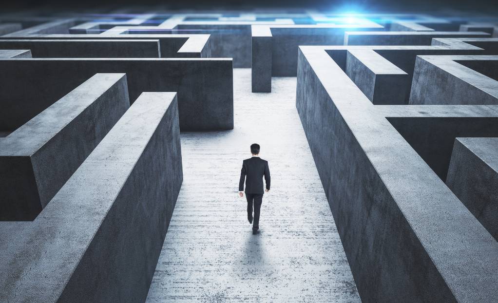 Illustration of roadblocks to commercialization in point-of-care diagnostics, showing a person navigating a maze with one glowing pathway forward.